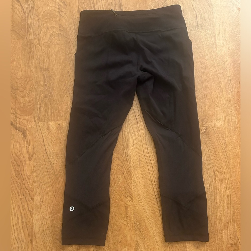lululemon black leggings with mesh detail on calf and back zipper pocket size 6